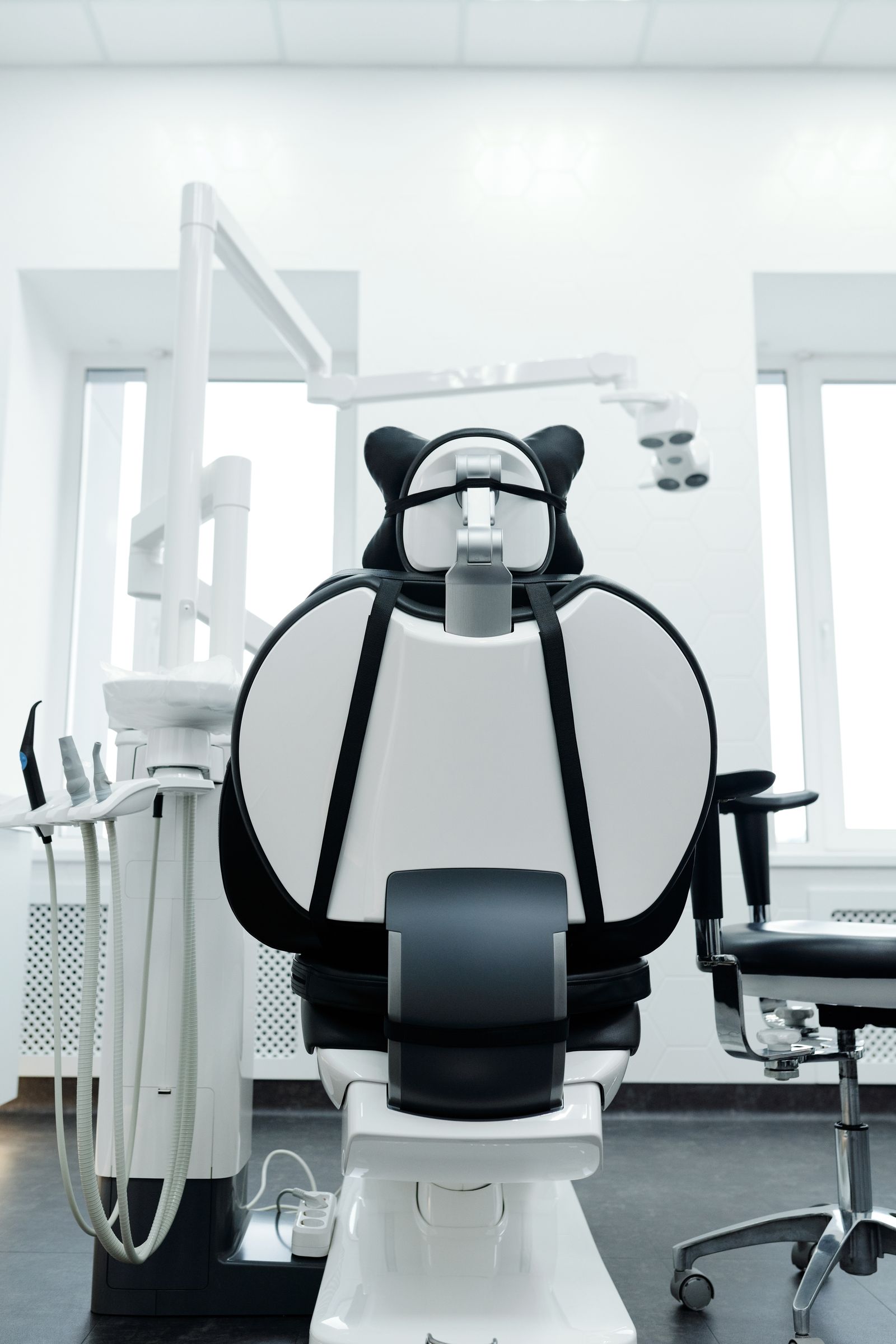 An empty modern dental operatory with the chair and overhead light ready